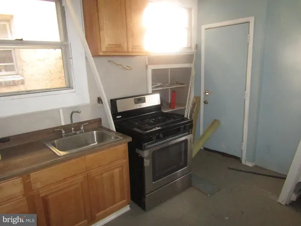 a kitchen with cabinets and a stove top oven