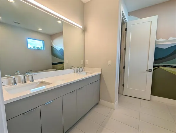 a bathroom with a double vanity sink and a mirror
