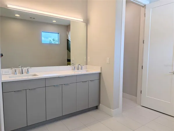a bathroom with a double vanity sink and a mirror