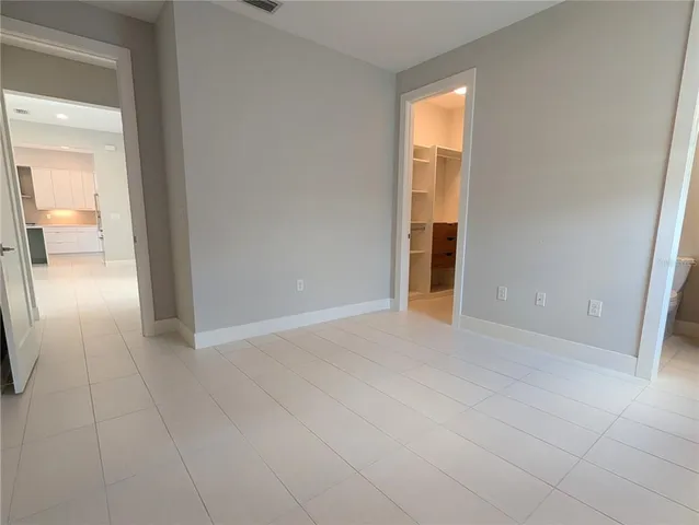 an empty room with entrance and windows