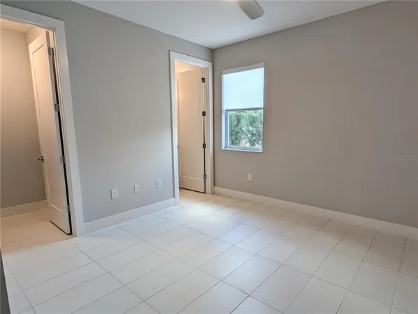 an empty room with windows and closet