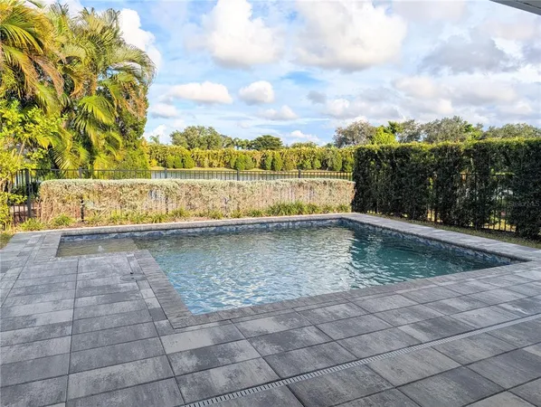 a view of a house with backyard sitting area and garden
