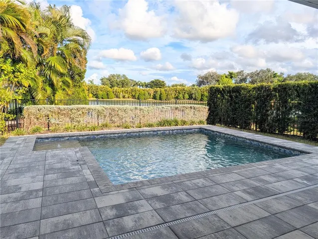 a view of a house with backyard sitting area and garden