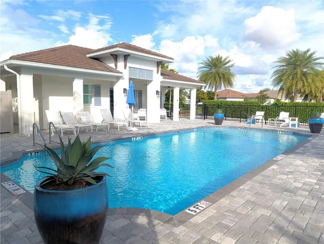 a view of swimming pool with outdoor seating and plants