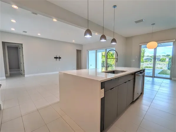 a large white kitchen with a large window
