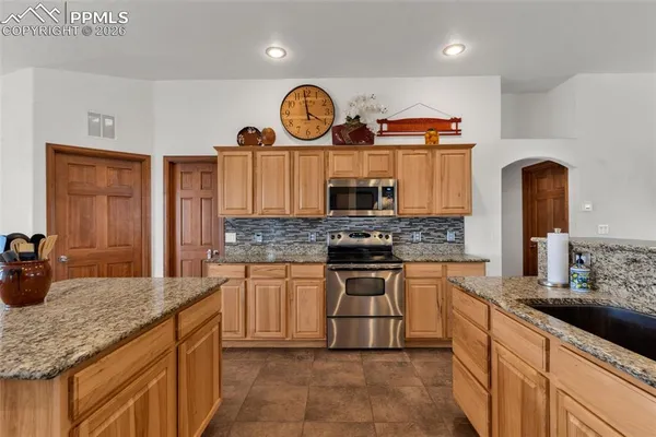 a kitchen with sink a counter and cabinets