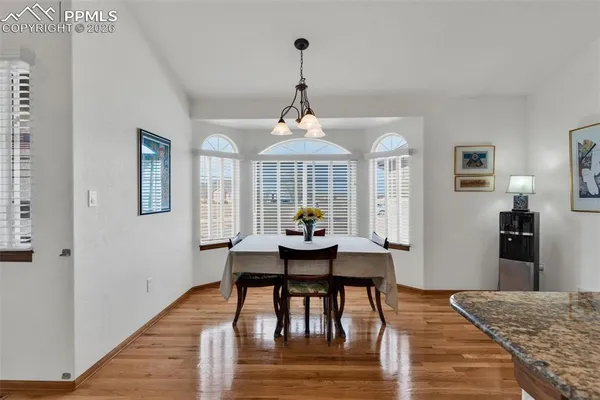 a view of a dining room with furniture window and wooden floor
