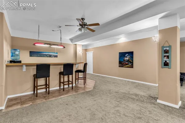 a view of a livingroom with furniture and a ceiling fan