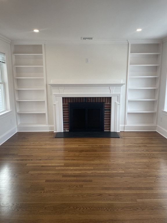 29 Crescent Road, Unit 29 Belmont, MA 02478 - Photo 4 of 21 a view of an empty room with a fireplace and a window