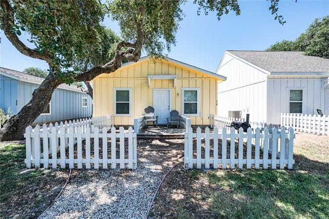 a view of a house with a yard and a porch