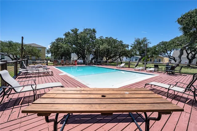 a view of a swimming pool with lounge chairs