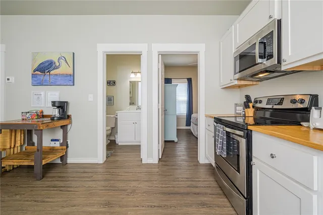 a kitchen with stainless steel appliances granite countertop a stove and a refrigerator