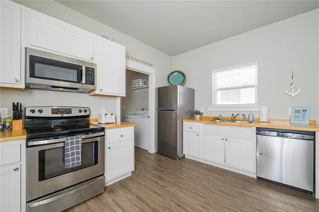 a kitchen with stainless steel appliances a stove microwave and refrigerator