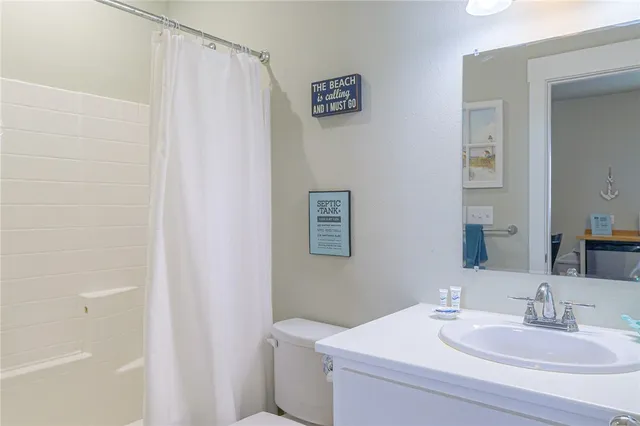 a bathroom with a sink toilet and vanity