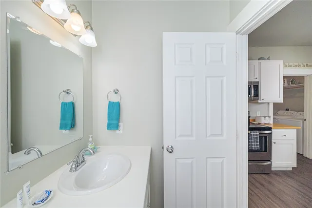 a bathroom with a sink vanity and a mirror