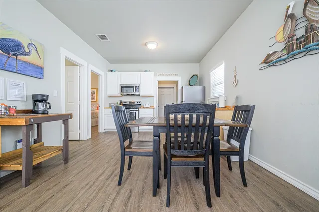 a view of a dining room with furniture and wooden floor