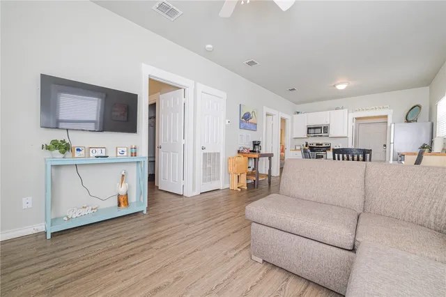 a living room with furniture and a wooden floor