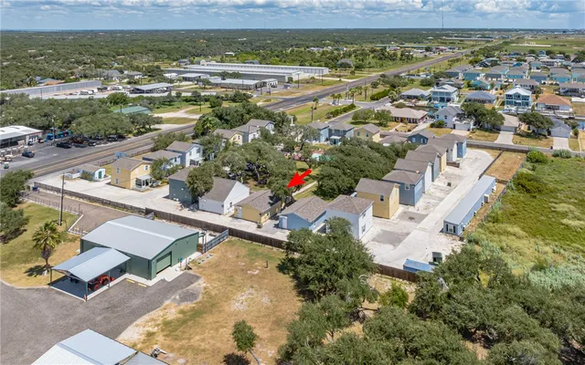 an aerial view of residential houses with outdoor space