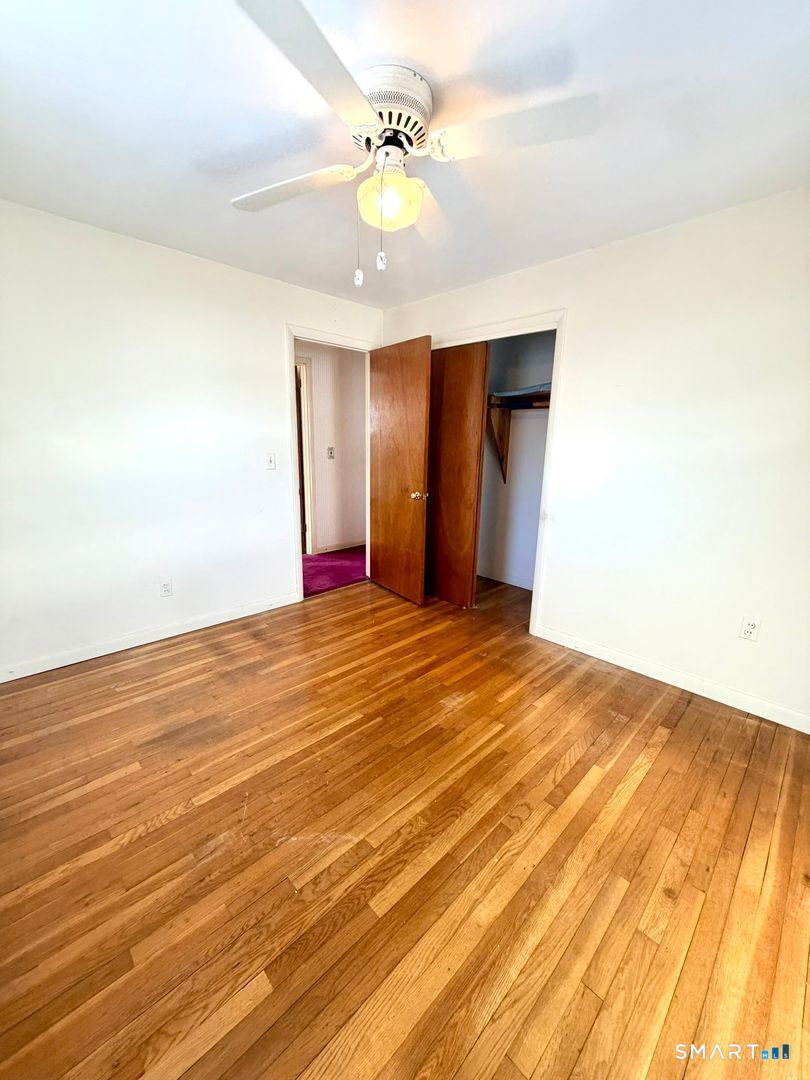 282 Horace Street Bridgeport, CT 06610 - Photo 12 of 16 a view of an empty room with wooden floor
