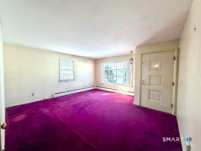 282 Horace Street Bridgeport, CT 06610 - Photo 3 of 16 an empty room with windows and closet
