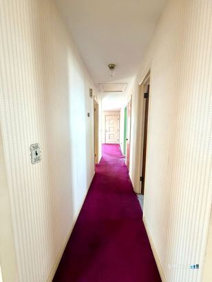 282 Horace Street Bridgeport, CT 06610 - Photo 8 of 16 a view of a hallway with wooden floor and a bathroom