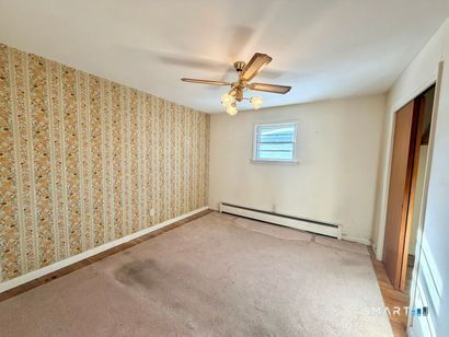 282 Horace Street Bridgeport, CT 06610 - Photo 9 of 16 an empty room with windows and fan