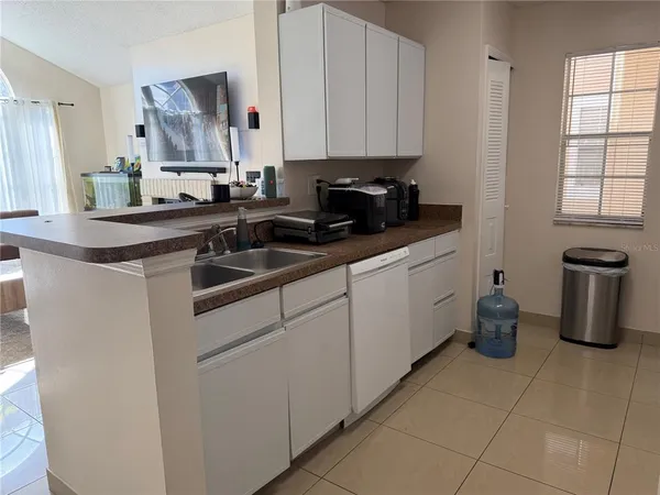 a kitchen with a sink cabinets and window