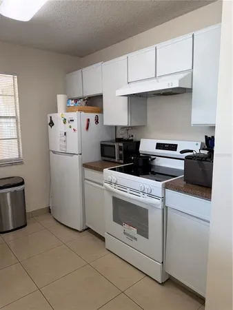 a kitchen with a cabinets and white appliances
