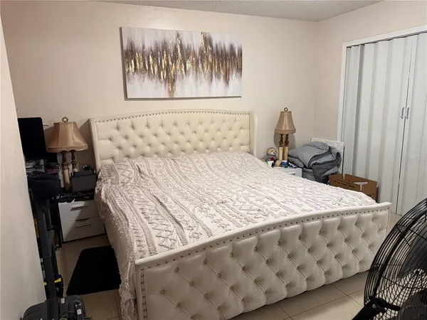 a bedroom with a bed and a chair
