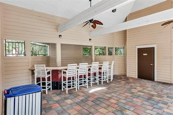 a view of a chairs and tables in backyard of the house