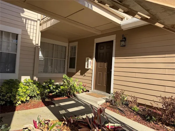 a view of a chairs and table in a back yard of the house