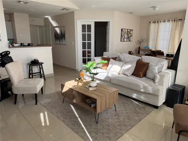a living room with furniture and a wooden floor