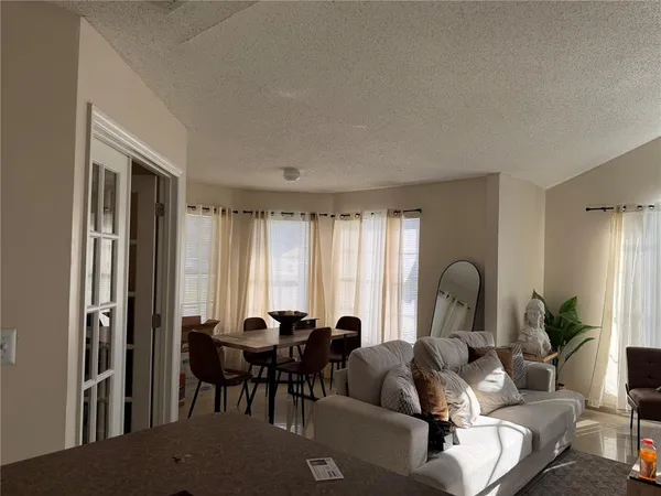 a living room with furniture potted plant and a window