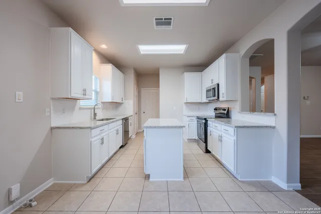 a large kitchen with stainless steel appliances lots of counter top space