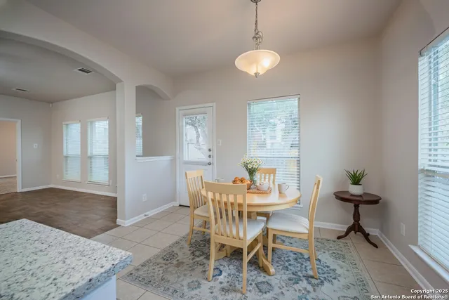 a dining room with furniture and window
