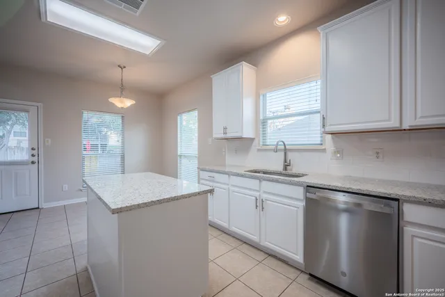 a kitchen that has a sink and a stove in it