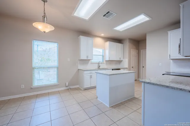 a kitchen with a stove a sink and a refrigerator