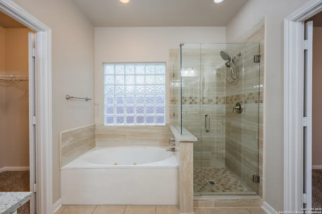 a bathroom with a bathtub and shower