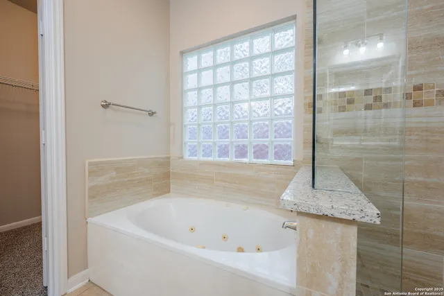 a white bath tub sitting next to a shower