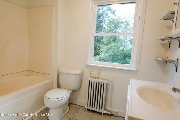 a bathroom with a toilet and a bathtub