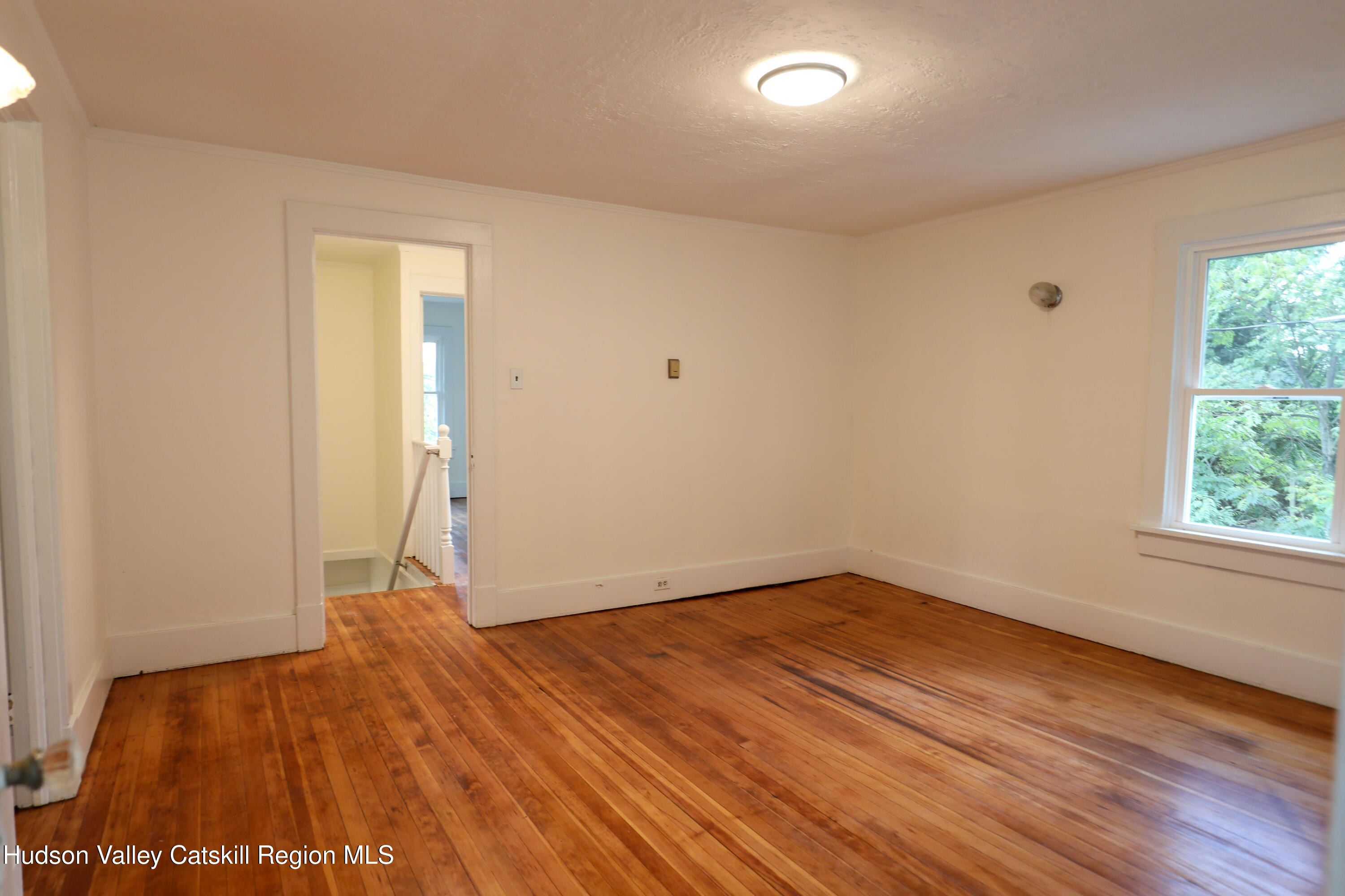 4294 Rte 9W, Unit 1 West Camp, NY 12490 - Photo 17 of 21 an empty room with wooden floor and windows