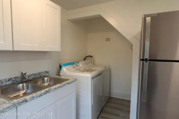 a kitchen with a sink and a refrigerator