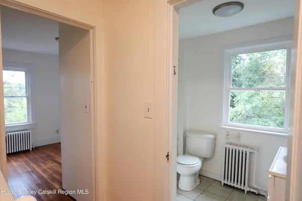 a bathroom with a toilet sink and a window