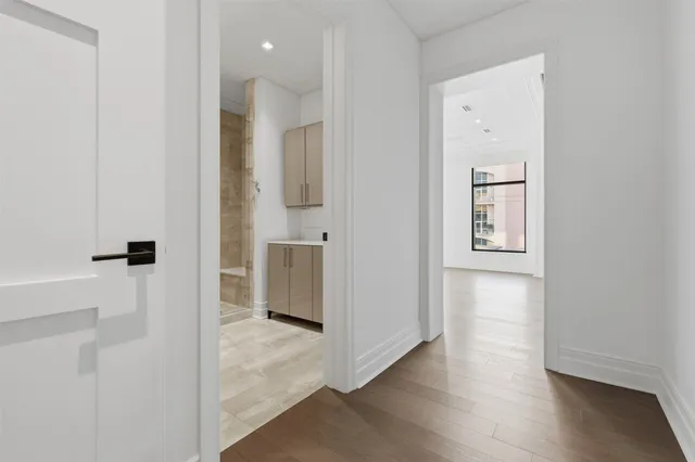 a view of hallway with wooden floor