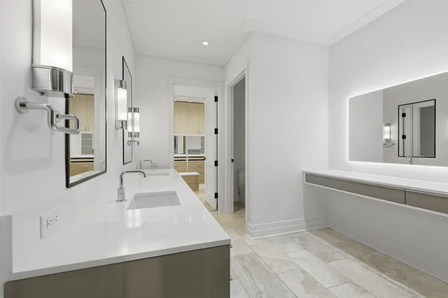 a bathroom with a tub sink and mirror