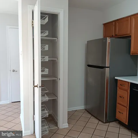 a kitchen with a refrigerator and cabinets