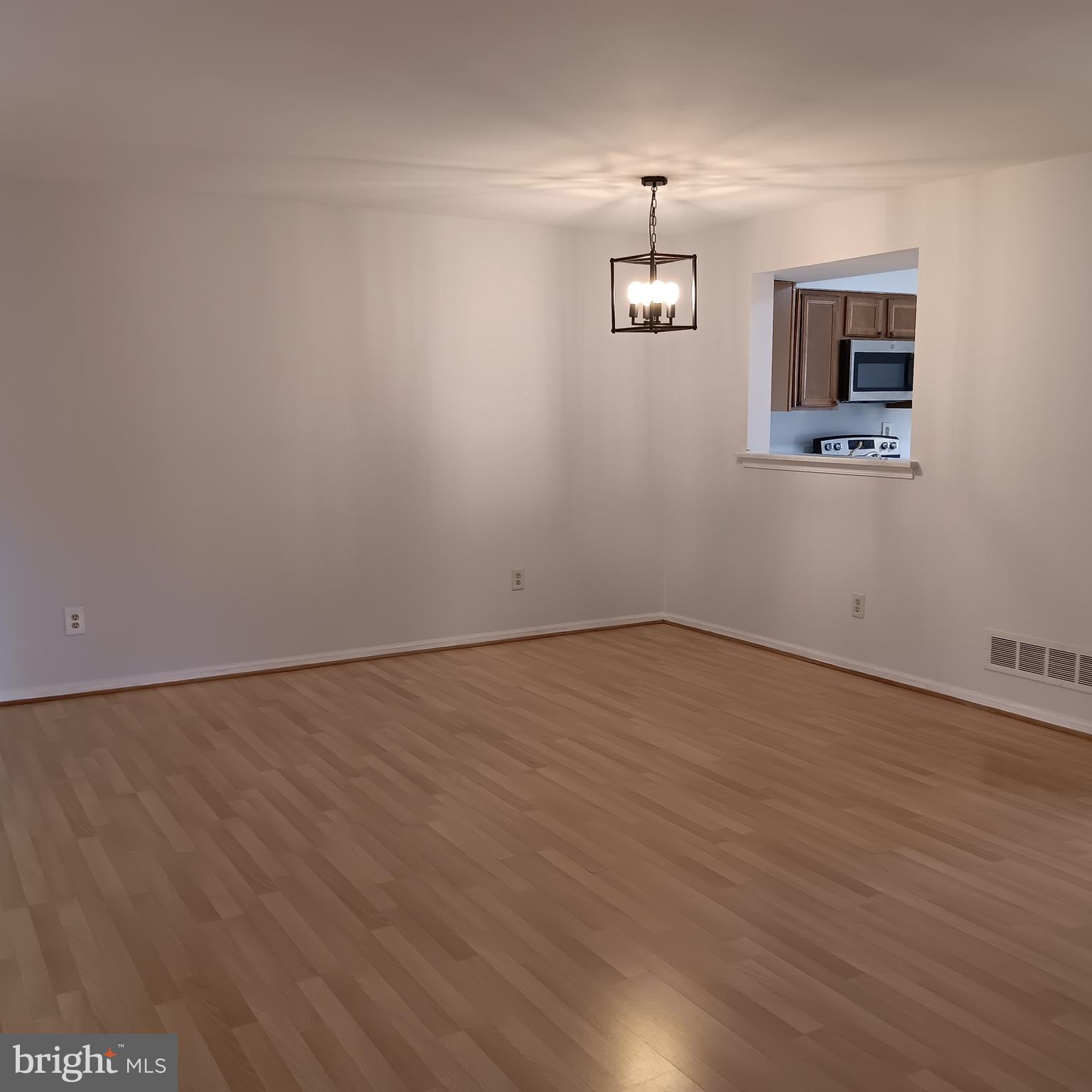 123 Caernarvon Court Exton, PA 19341 - Photo 12 of 43 an empty room with a wooden floor and a ceiling fan
