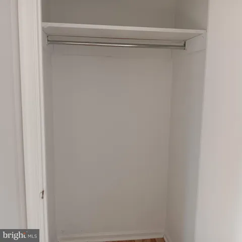 a view of a hallway with wooden floor and stairs