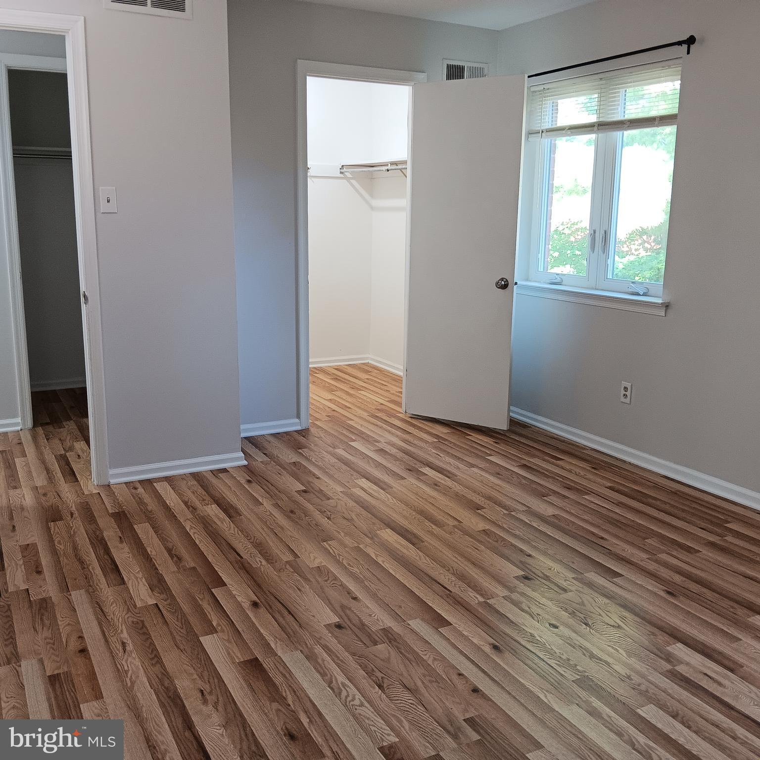 123 Caernarvon Court Exton, PA 19341 - Photo 26 of 43 an empty room with wooden floor and windows