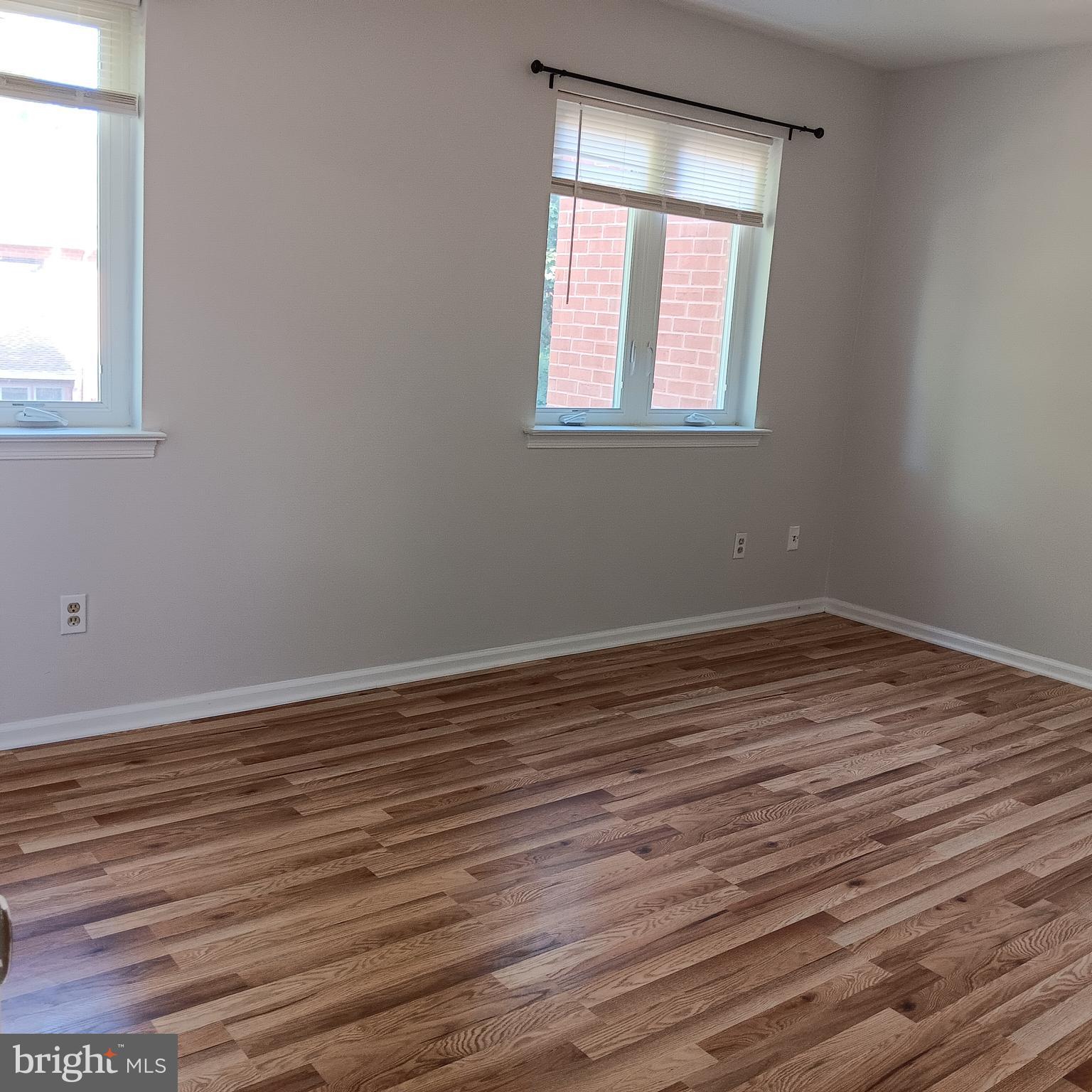 123 Caernarvon Court Exton, PA 19341 - Photo 27 of 43 a view of an empty room with wooden floor and a window